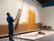 Artist demonstrating mural painting techniques indoors.